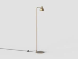 En moderne gulvlampe i guld med en buet arm og en kuppelformet lampeskærm, der står på en rund fod med en synlig sort strømledning og afbryder på en ensfarvet lys baggrund.