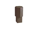 En høj, mørk, geometrisk skulptur med en ottekantet top og en rektangulær base, placeret foran en ensfarvet hvid baggrund.