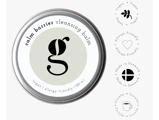 En metalbeholder med Calm Barrier Cleansing Balm, ledsaget af symboler, der angiver, at produktet er vegansk, allergivenligt, fremstillet i Danmark og cirkulært.