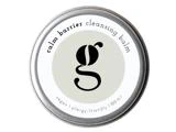 Rund dåse med Calm Barrier Cleansing Balm med et g-logo i midten, mærket som vegansk og allergivenlig.