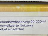 Den tyske tekst på emballagen lyder: "chenbewässerung 90-220m² komplizierte Nutzung xibel einsetzbar" på en gul og hvid baggrund.