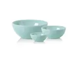 Tre lyseblå keramikskåle i forskellige størrelser er anbragt ved siden af hinanden på en hvid baggrund.