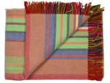 Et foldet uldtæppe med farverige striber i grøn, rød, blå og orange og med flerfarvede frynser langs kanten.