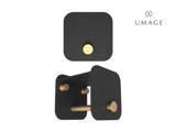 Væghængt toiletpapirholder i sort og guld med et moderne, minimalistisk design, vist oppefra og fra en skrå vinkel. UMAGE-logo i øverste højre hjørne.