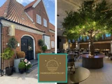 En murstensbygning med et skilt for Vadehavshotellet og et moderne restaurantinteriør med et stort træ med lyskæder i midten.