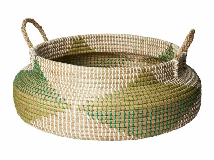 Rund flettet kurv med to hanke og et mønster af beige, grønne og lysebrune farver.