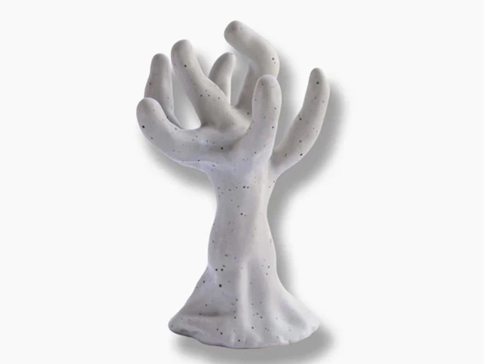 Hvid keramikskulptur, der ligner et abstrakt træ eller en hånd med flere udstrakte, afrundede grene eller fingre, placeret på en almindelig baggrund.