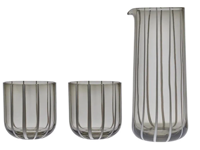 En høj glaskande og to matchende kander med lodrette grå striber på klart glas, vist på en hvid baggrund.