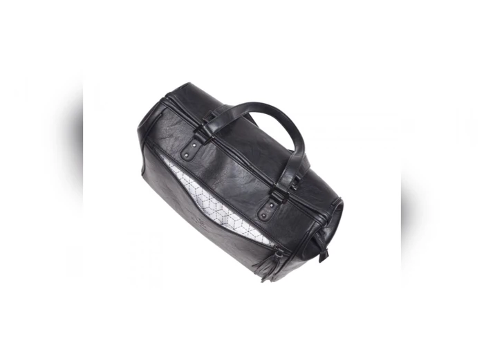 En sort lædertaske med to hanke, der er delvist åbnet for at afsløre et mønstret stoffor indeni.