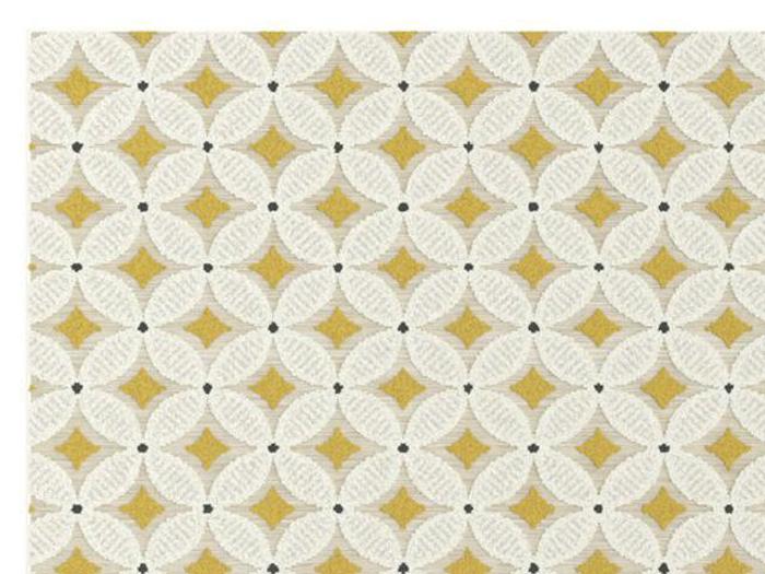 Geometrisk mønster med hvide cirkler, der griber ind i hinanden, gule diamantformer i skæringspunkterne og små sorte prikker på en beige baggrund.