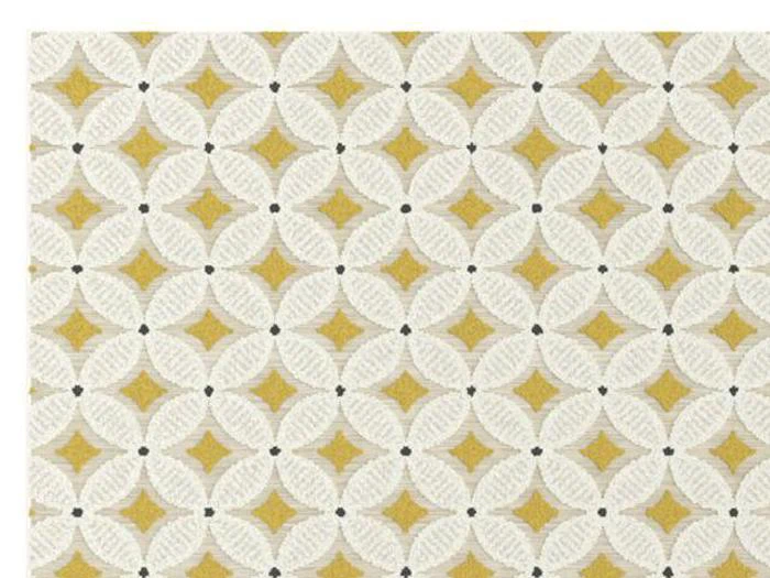 Geometrisk mønster med hvide cirkler, der griber ind i hinanden, gule diamantformer i skæringspunkterne og små sorte prikker på en beige baggrund.