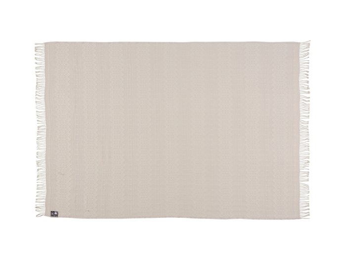 Et lysbeige vævet tæppe med korte frynser på venstre og højre kant, vist fladt mod en hvid baggrund.