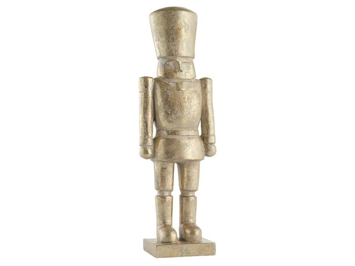 En nøddeknækkerfigur i metallisk guld, der står på en firkantet sokkel.