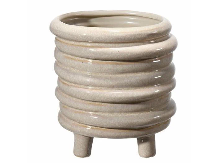 Lysbeige keramisk urtepotte med et ribbet mønster og korte ben.