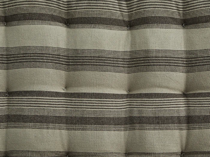 Hvid keramisk hængeplante med et struktureret, hævet prikmønster, ophængt i to solbrune lædersnore, der er bundet i toppen.