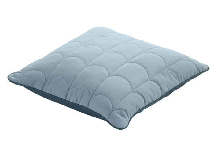 En lyseblå, kvadratisk, quiltet pude med afrundede kanter og et enkelt, syet mønster på overfladen.