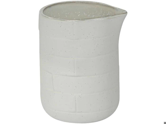 En lille, hvid kande i keramik med et fint strukturmønster og en tud på en ensfarvet baggrund.