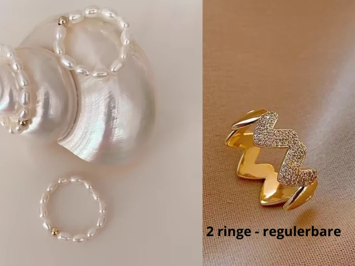 To perleringe på en skinnende skal og en zigzag-ring i guld med krystaller på et beige stof. Teksten lyder: 2 ringe - regulerbare.