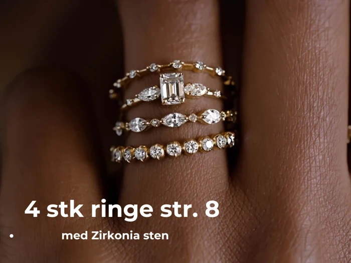 Nærbillede af fire guldringe med zirkonia-sten stablet på en finger; teksten lyder 4 stk ringe str. 8 med Zirkonia sten.